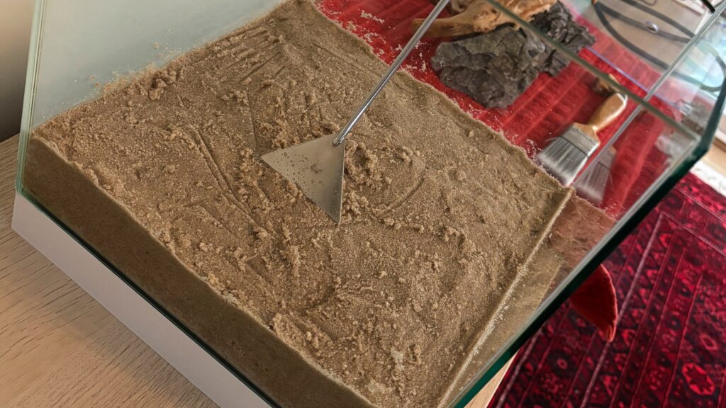 Sand in the bottom of a cube aquarium for an aquascape substrate