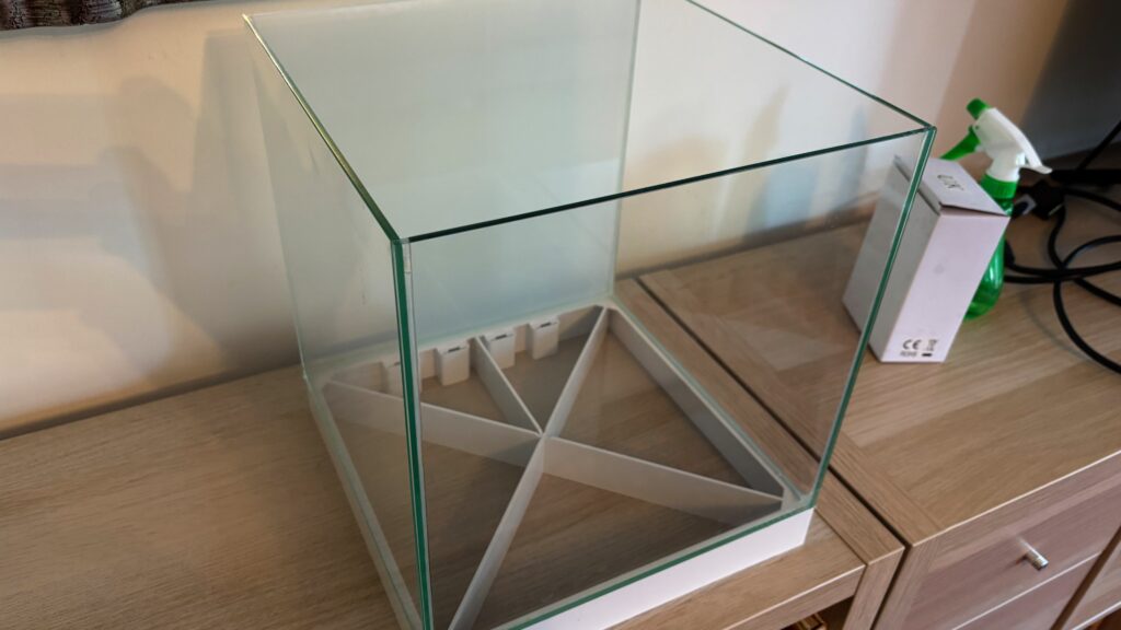 Empty cube fish tank on base